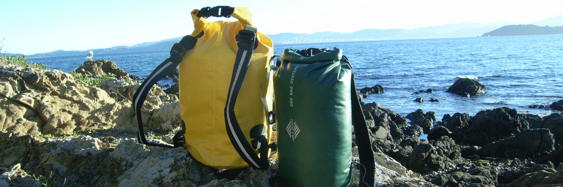 mariner dry bags on rock near harbour